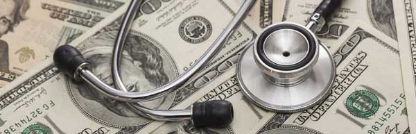 stethoscope on top of a pile of cash