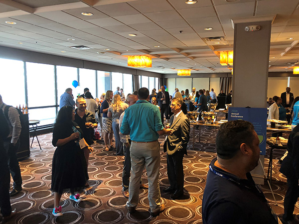 businesspersons conversing in a conference room during a social hour 