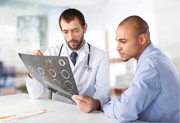 young doctor explaining x-ray images to his patient
